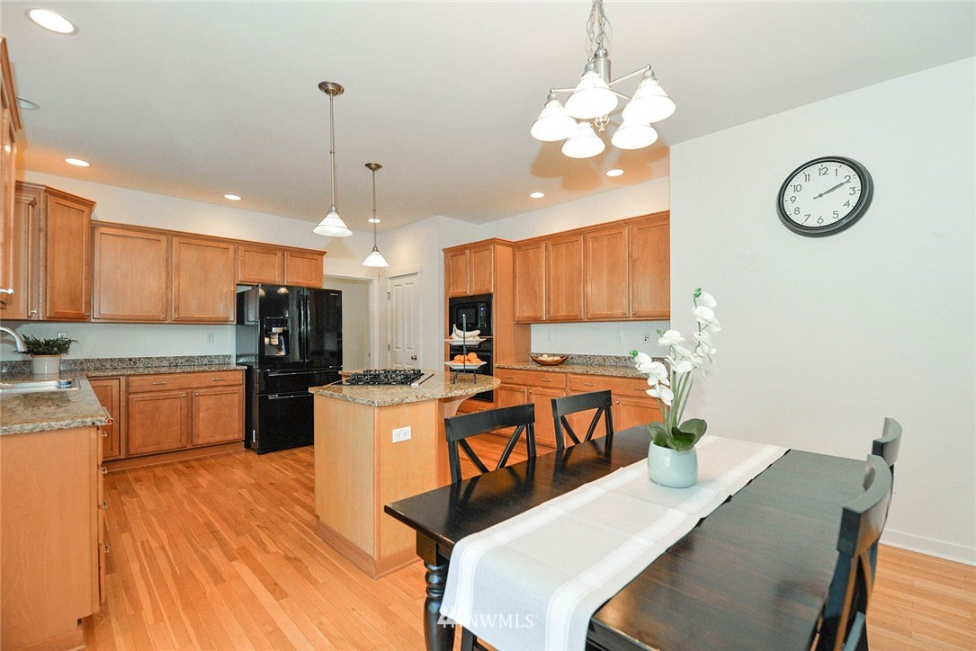21814 41st Avenue Southeast Bothell, WA 98021 - Photo 13 of 30 a large kitchen with a table and chairs