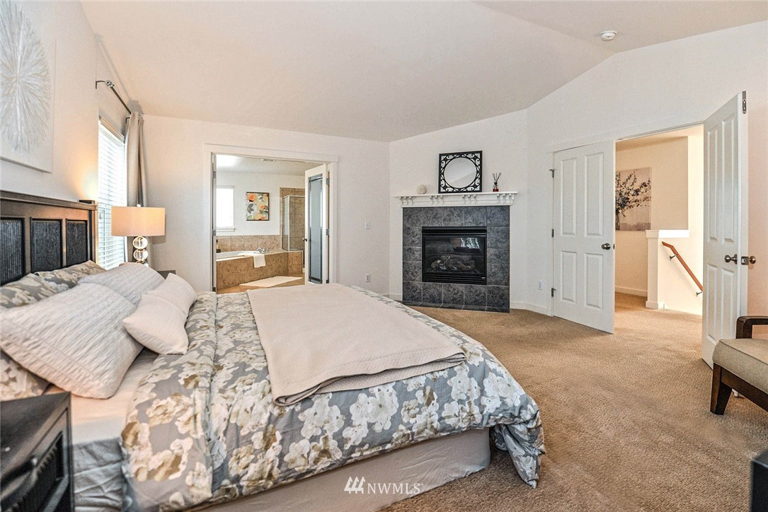 21814 41st Avenue Southeast Bothell, WA 98021 - Photo 20 of 30 a bedroom with a bed and a fireplace