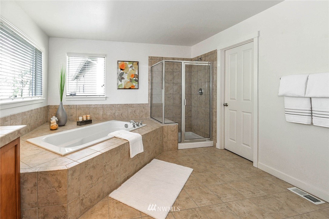 21814 41st Avenue Southeast Bothell, WA 98021 - Photo 22 of 30 a spacious bathroom with a tub sink and mirror