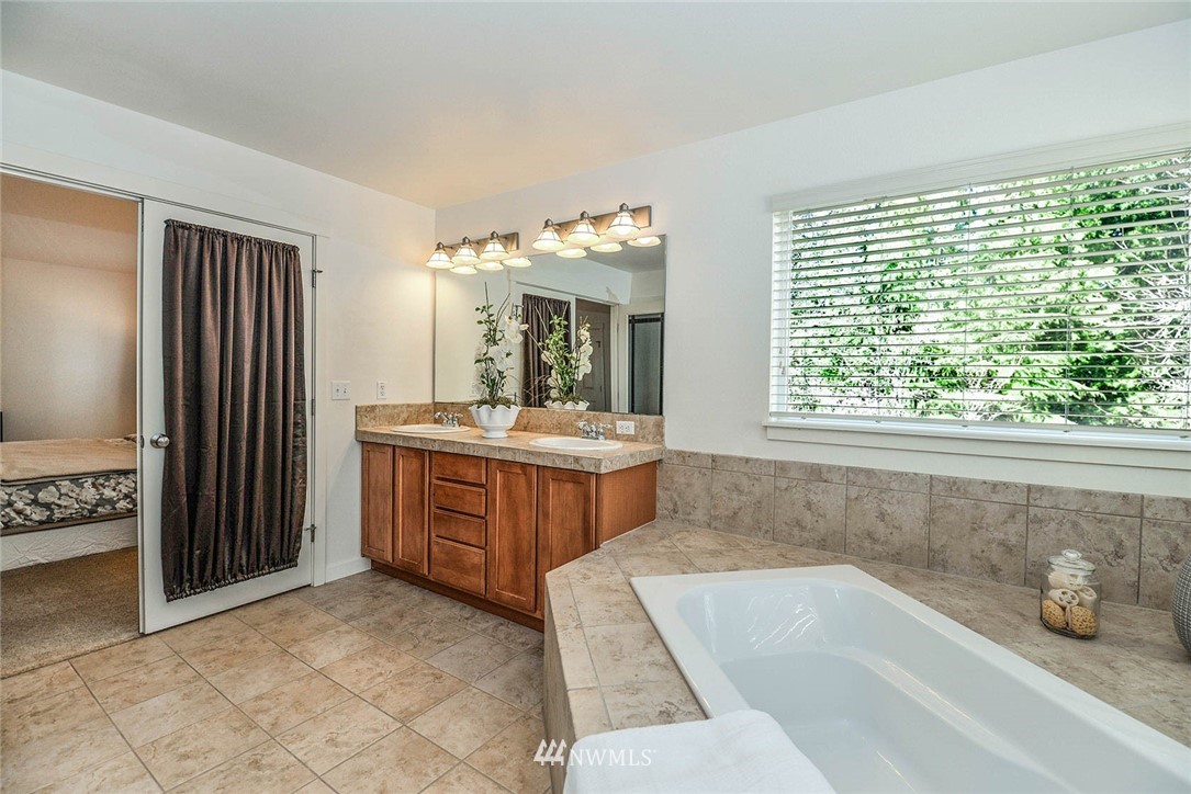 21814 41st Avenue Southeast Bothell, WA 98021 - Photo 23 of 30 a bathroom with a tub sink and mirror