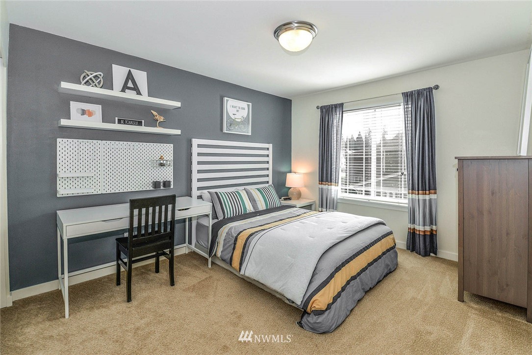 21814 41st Avenue Southeast Bothell, WA 98021 - Photo 27 of 30 a bedroom with a bed and a window