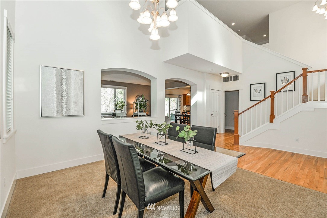 21814 41st Avenue Southeast Bothell, WA 98021 - Photo 6 of 30 a view of a dining room with furniture and a chandelier