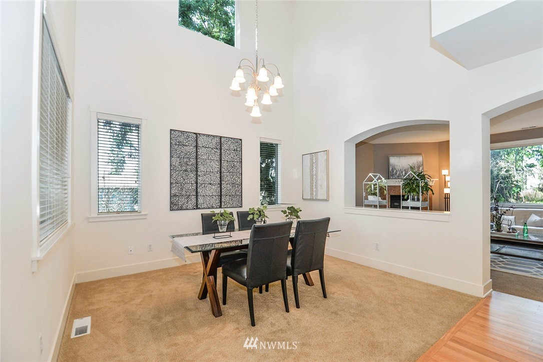 21814 41st Avenue Southeast Bothell, WA 98021 - Photo 7 of 30 a view of a dining room with furniture a chandelier and wooden floor