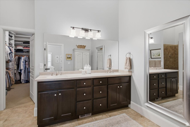 1257 Rigby Road Kaysville, UT 84037 - Photo 28 of 55 Double vanity featuring dark wood cabinetry, light countertops, and individual sinks