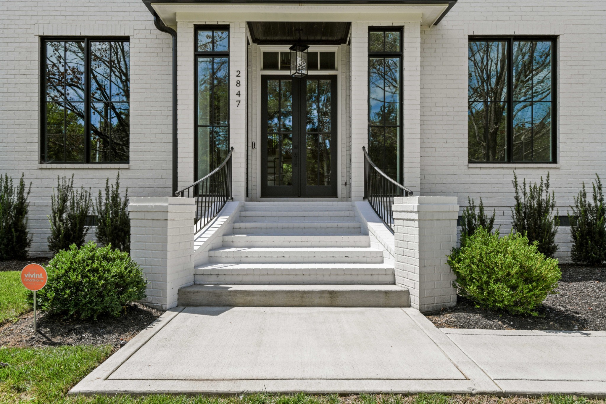 a front view of a house with a garden