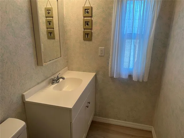 a bathroom with a sink and mirror