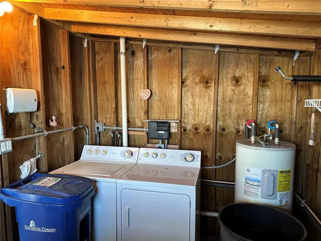 a room with a table chairs and a refrigerator