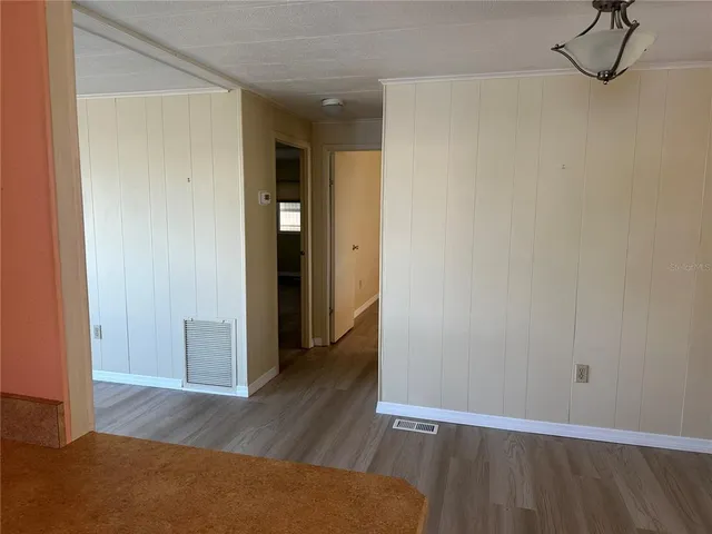 a view of hallway with wooden floor