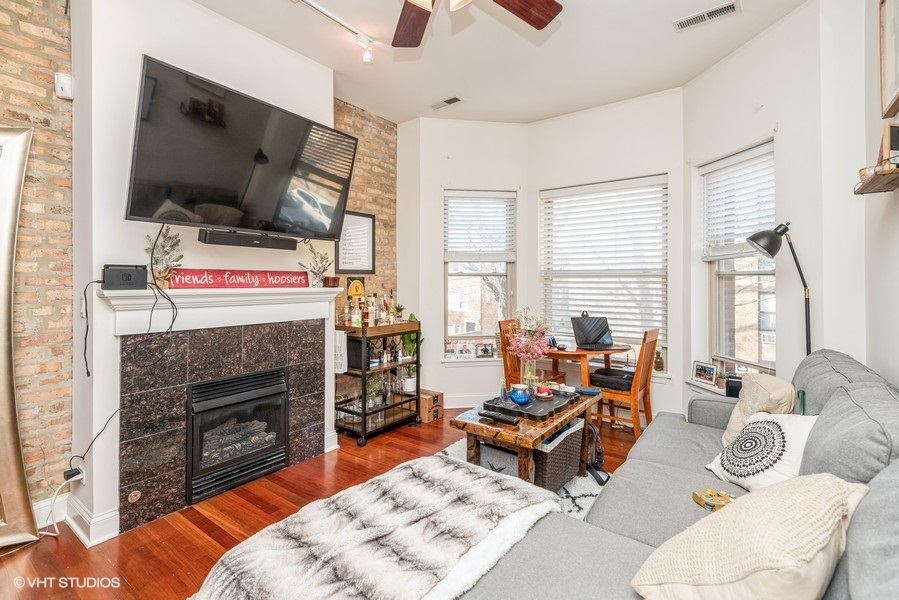 Undisclosed Address Chicago, IL 60614 - Photo 5 of 9 a living room with furniture a flat screen tv and a fireplace