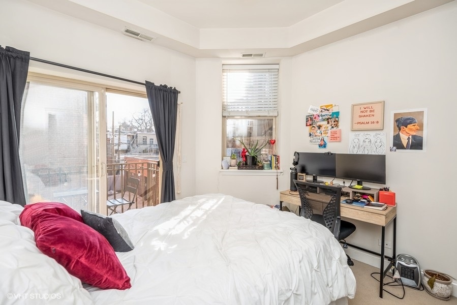 Undisclosed Address Chicago, IL 60614 - Photo 6 of 9 a bedroom with a bed and a large window with chair