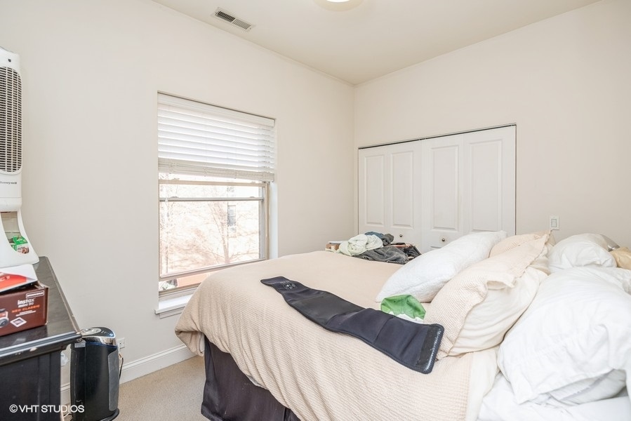 Undisclosed Address Chicago, IL 60614 - Photo 7 of 9 a bedroom with a bed and a window