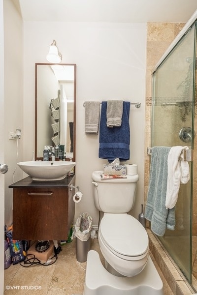 Undisclosed Address Chicago, IL 60614 - Photo 9 of 9 a bathroom with a toilet a sink and mirror