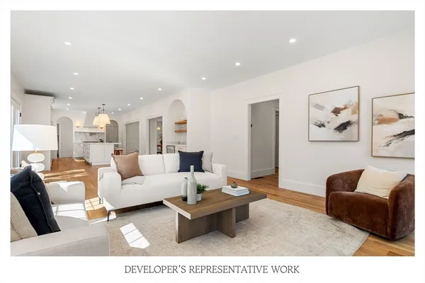 a living room with furniture potted plant and a fireplace