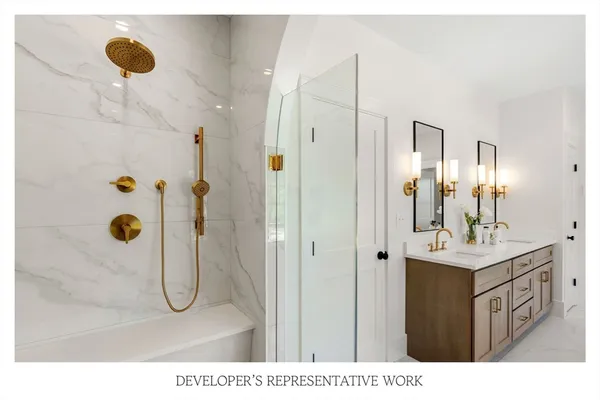 a en suite bathroom with a double vanity sink a mirror and a bathtub