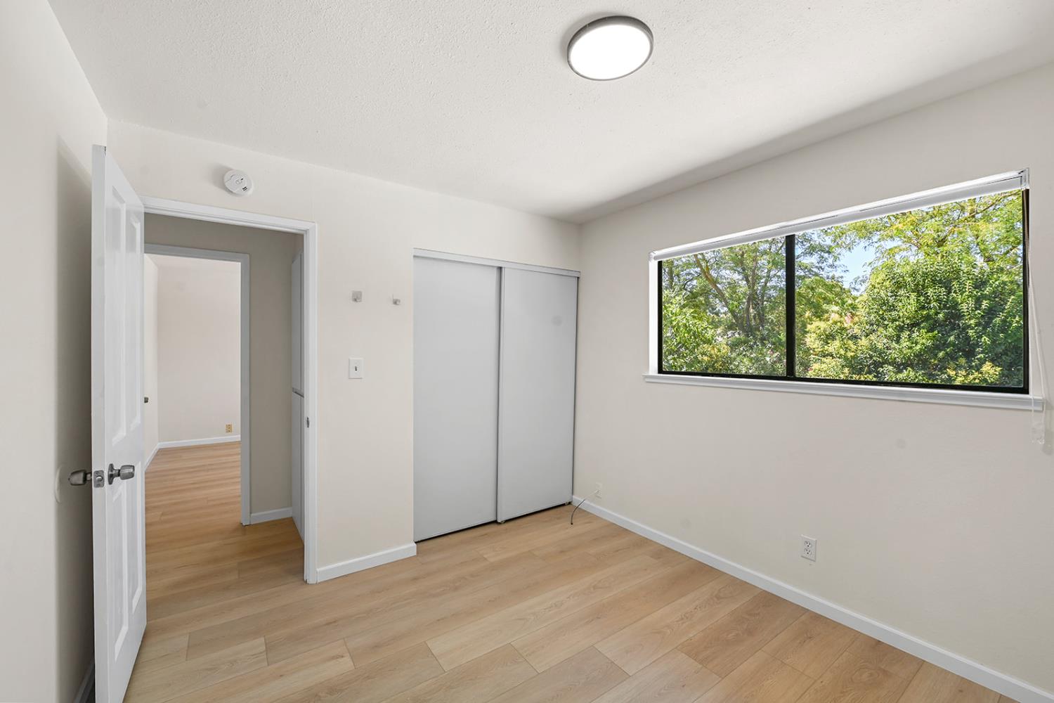 4121 Vista Way Davis, CA 95618 - Photo 18 of 32 wooden floor in an empty room with a window