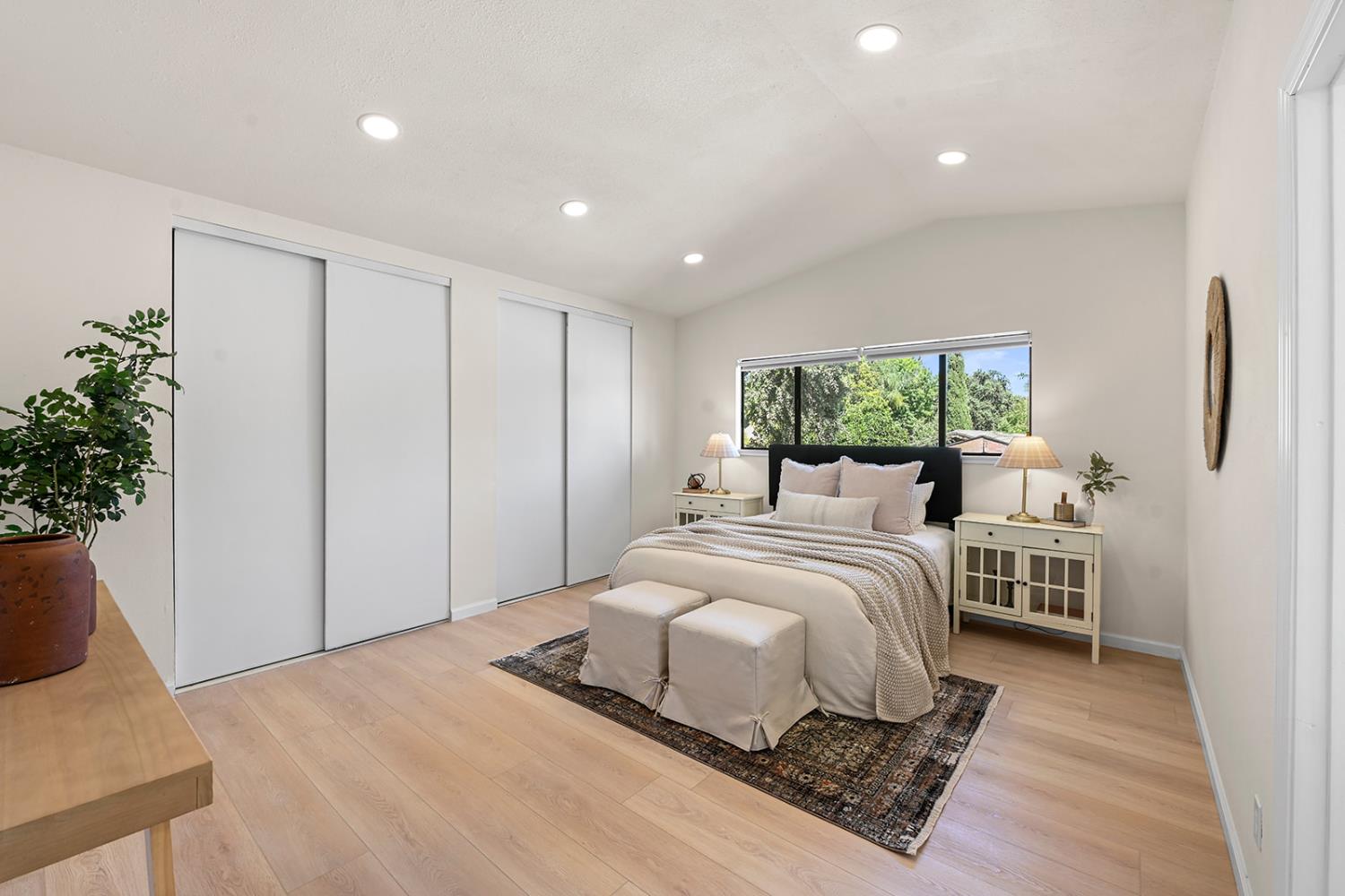 4121 Vista Way Davis, CA 95618 - Photo 23 of 32 a bedroom with a large bed and a potted plant