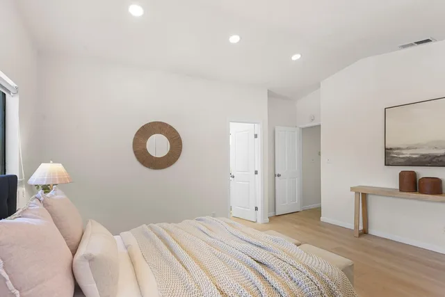 a bedroom with a bed and a lamp