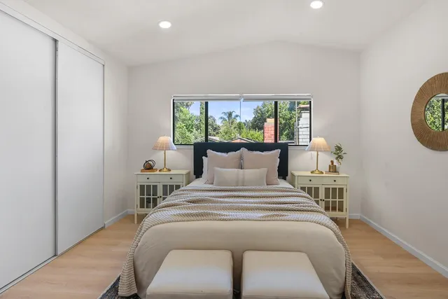 a bedroom with a bed and a window