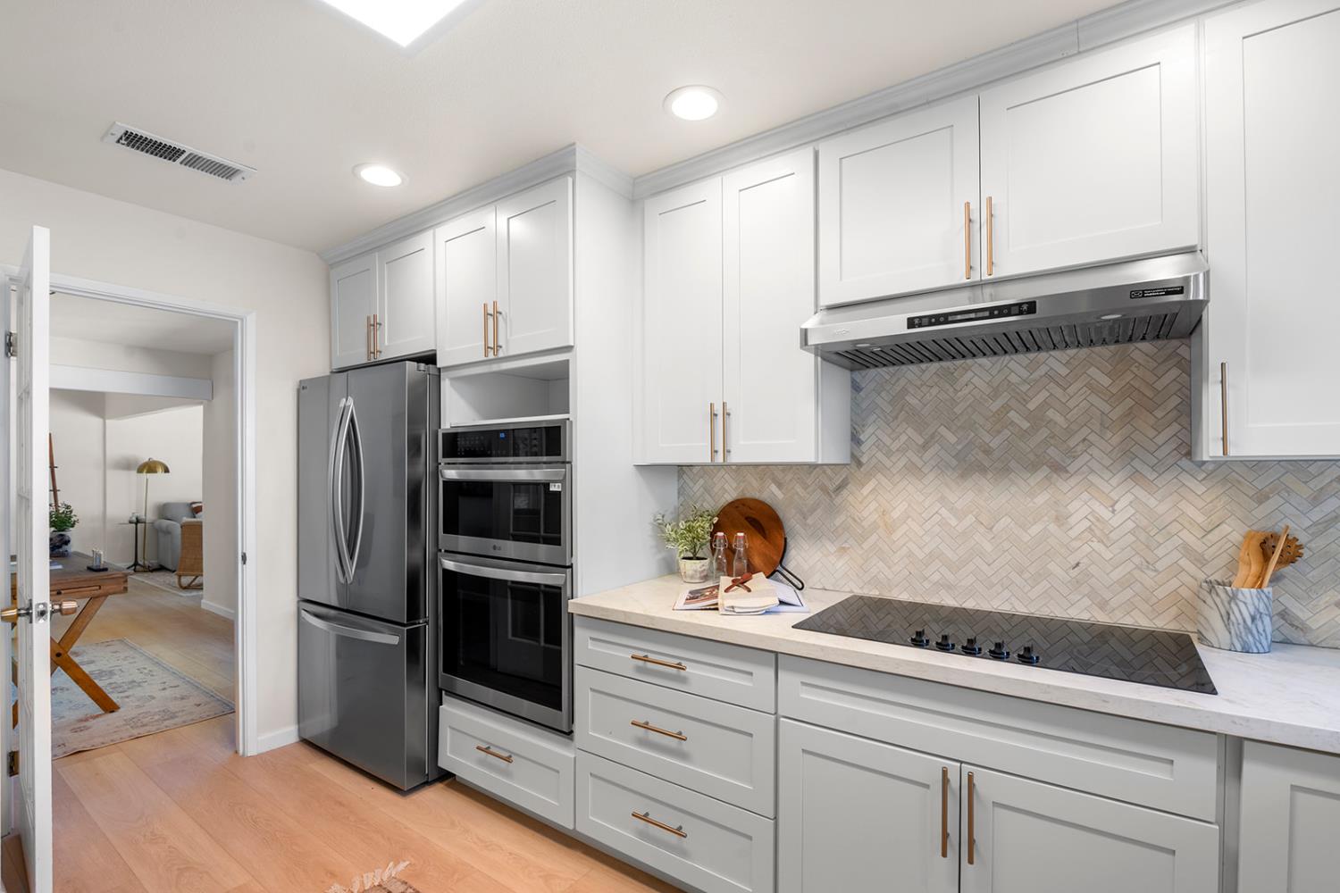 4121 Vista Way Davis, CA 95618 - Photo 9 of 32 a kitchen with stainless steel appliances granite countertop a refrigerator and a sink