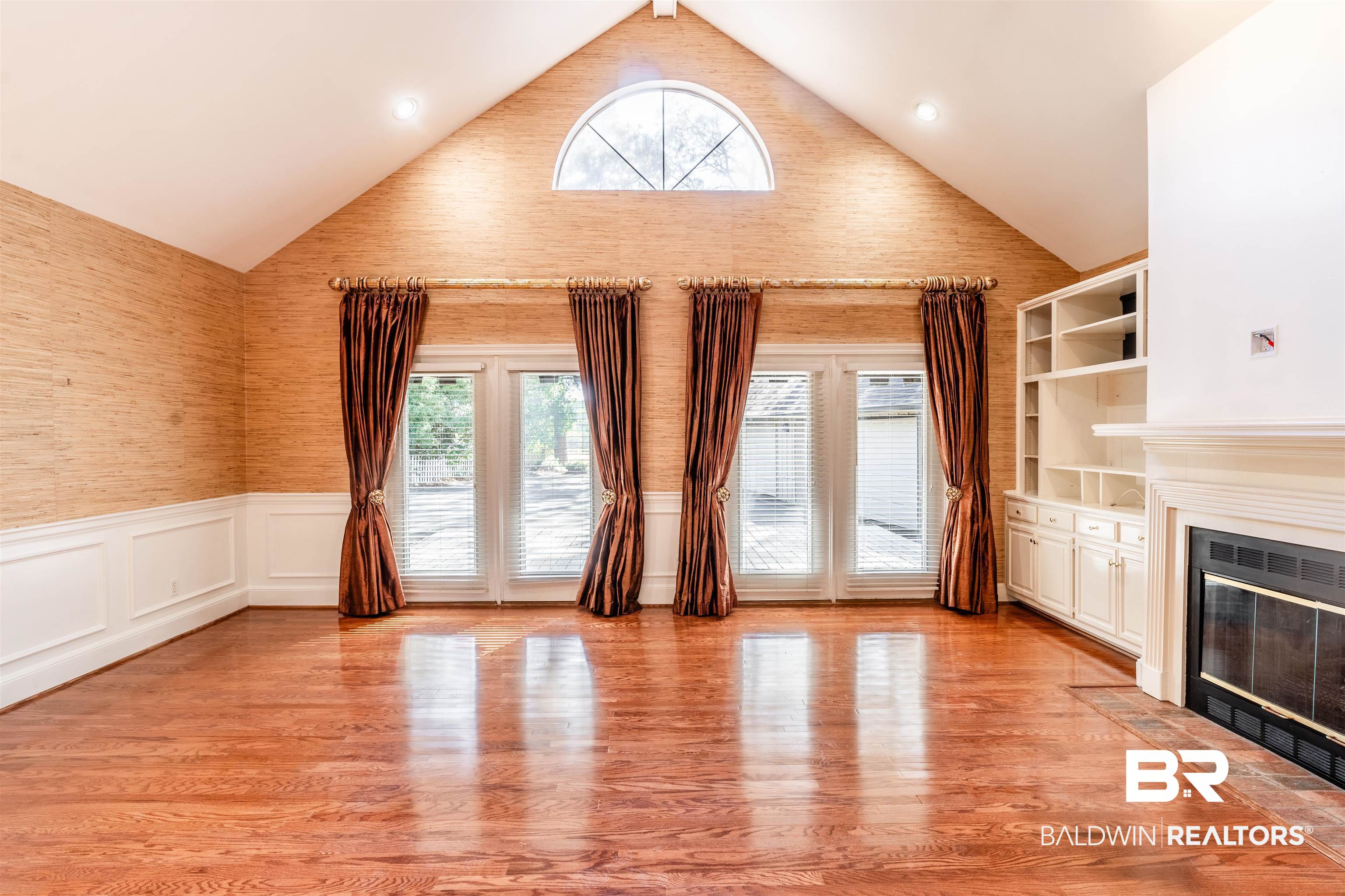 3821 St Andrews Loop East Mobile, AL 36693 - Photo 33 of 41 Unfurnished living room with light wood-type flooring and high vaulted ceiling