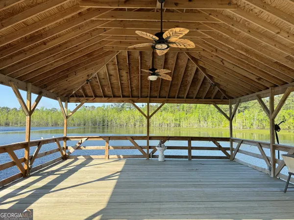 a roof deck with table and chairs under an umbrella