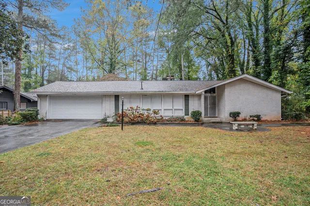 a view of a house with swimming pool and sitting area