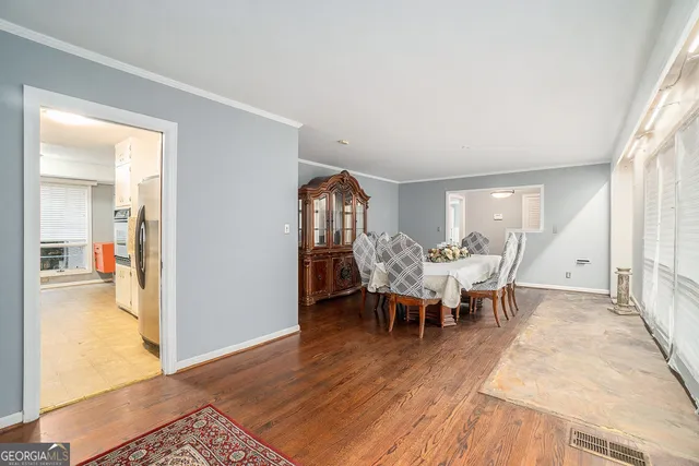 a view of a dining room with furniture and wooden floor