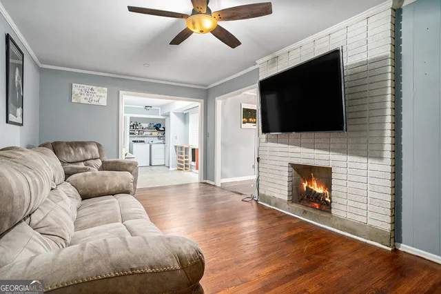 a living room with furniture a flat screen tv and a fireplace