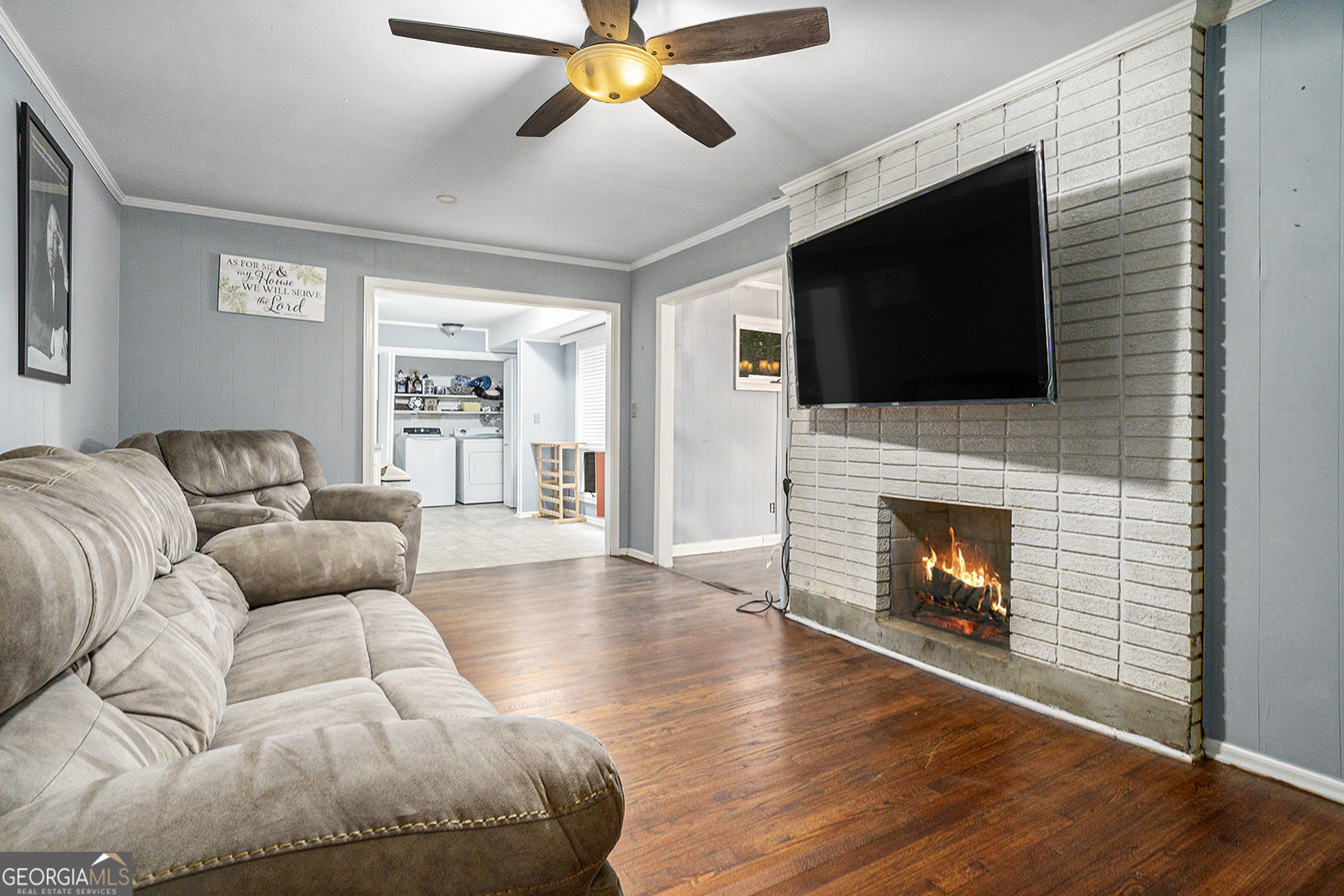 3382 Bobolink Circle Southwest Atlanta, GA 30311 - Photo 8 of 15 a living room with furniture a flat screen tv and a fireplace
