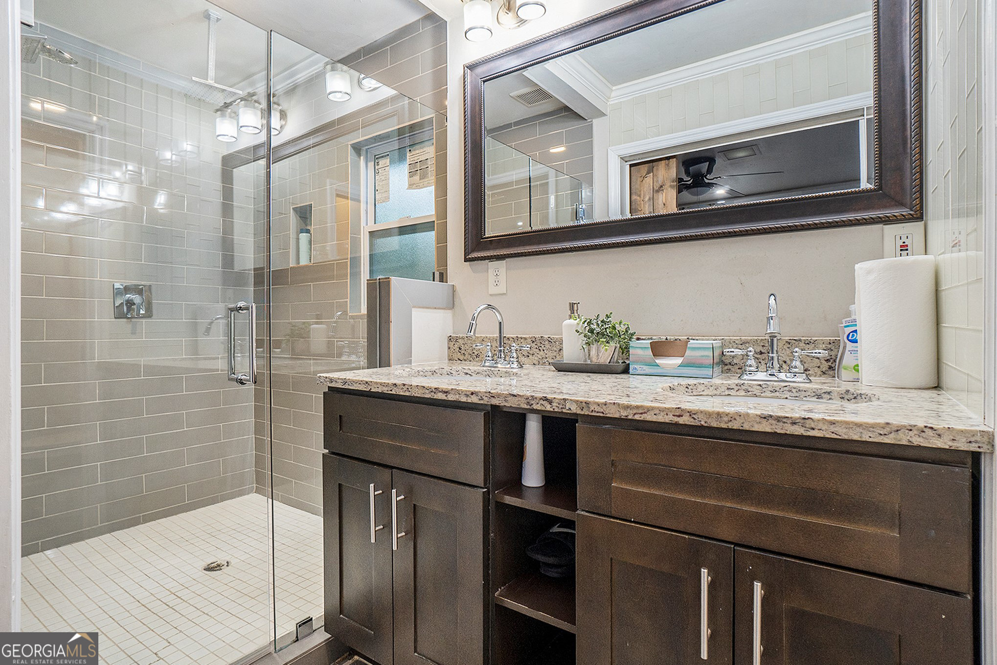 3382 Bobolink Circle Southwest Atlanta, GA 30311 - Photo 10 of 15 a bathroom with a granite countertop sink a mirror and shower