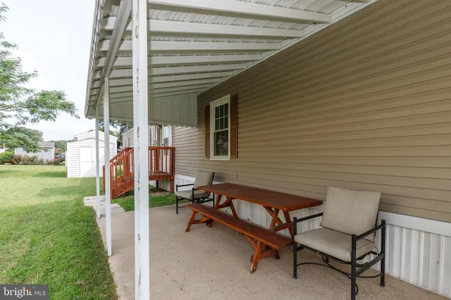 a view of a chairs in backyard of house