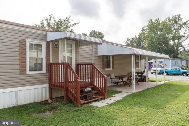 a view of a house with a yard porch and sitting area