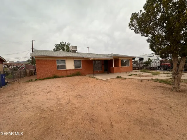 a view of a house with a yard and sitting area