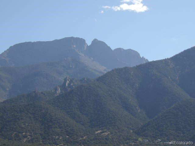 836 Pine Cone Road Crestone, CO 81131 - Photo 4 of 4 a view of a dry yard with mountains in the background