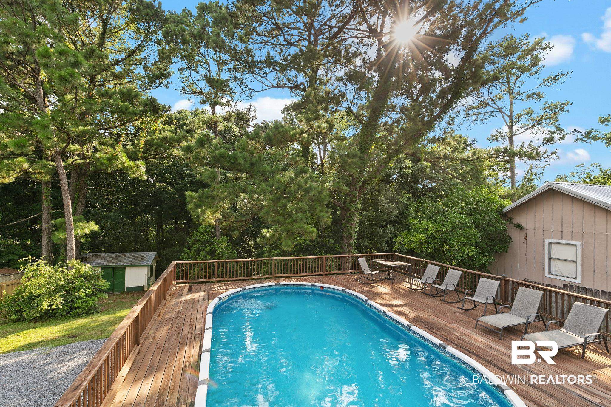14 Lee Circle Daphne, AL 36527 - Photo 62 of 83 View of pool with a wooden deck and an outdoor structure