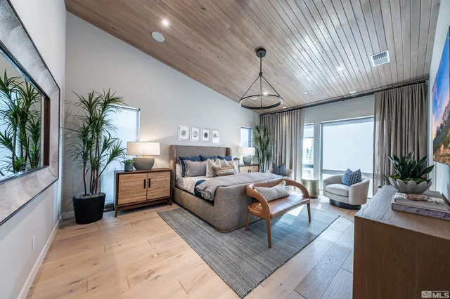 a bedroom with furniture and a large window