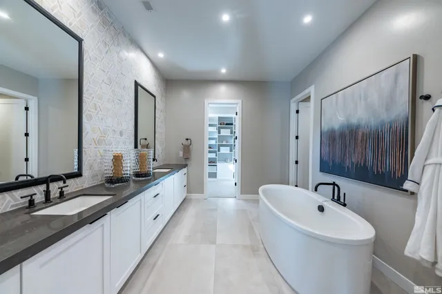 a bathroom with a granite countertop sink mirror bathtub and shower