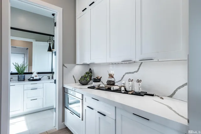 a kitchen with white cabinets and a sink
