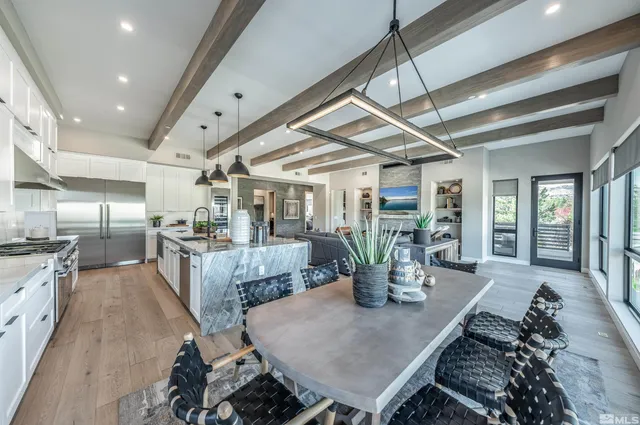 a kitchen with a table chairs and wooden floor