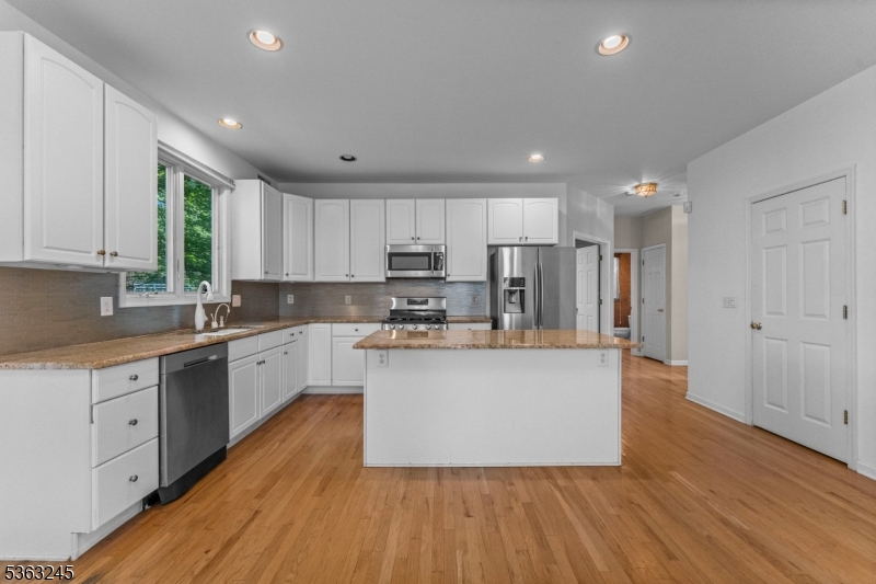 2 Seminole Road Skillman, NJ 08558 - Photo 17 of 50 a large kitchen with wooden floors stainless steel appliances a sink and cabinets