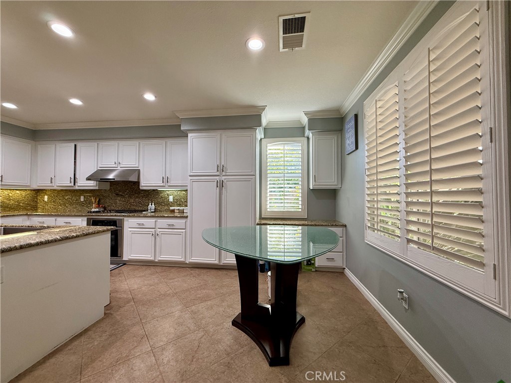 33467 Pitman Lane Menifee, CA 92584 - Photo 14 of 40 a kitchen with sink refrigerator and cabinets