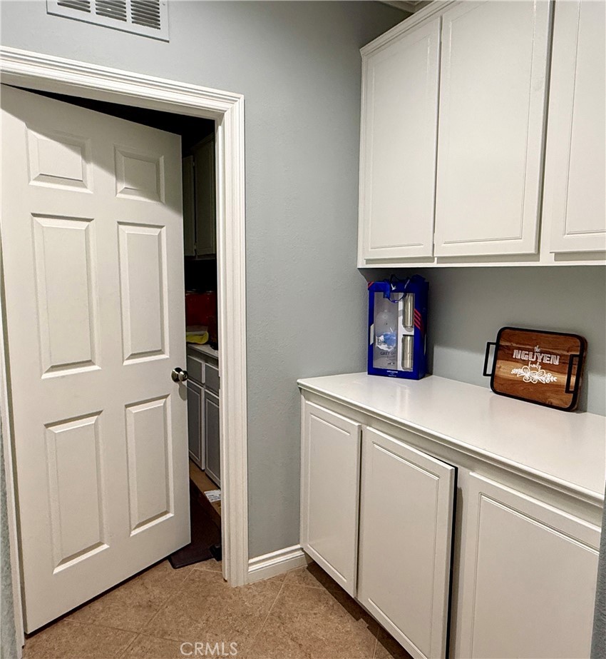 33467 Pitman Lane Menifee, CA 92584 - Photo 16 of 40 a kitchen with white cabinets and white appliances