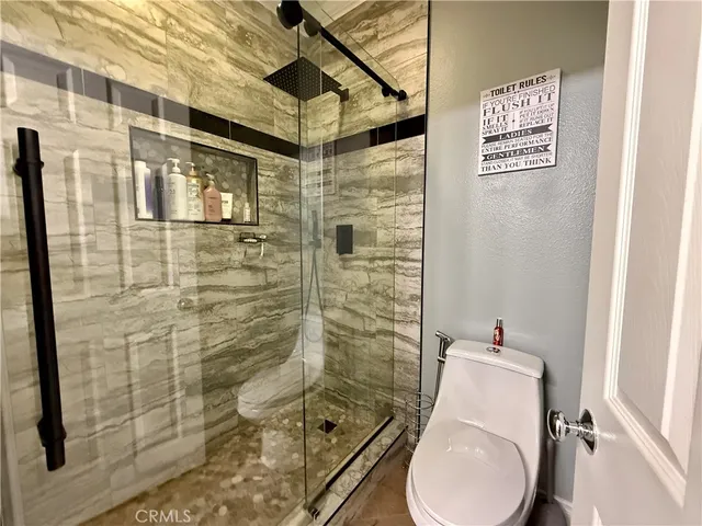 a bathroom with a shower and toilet