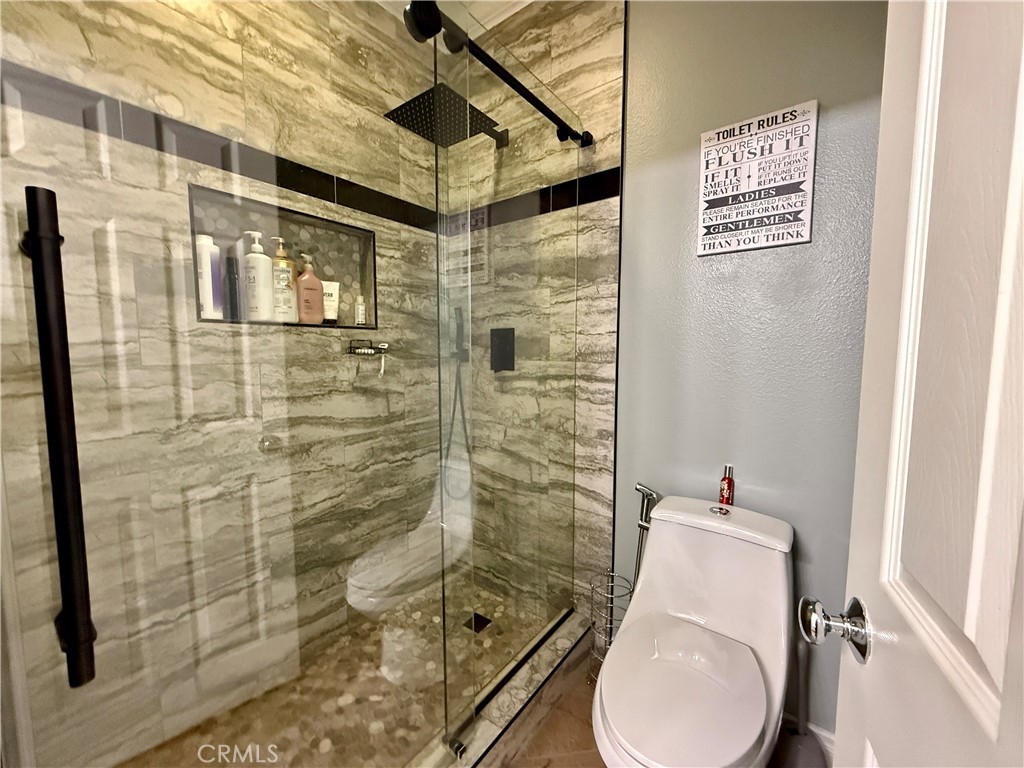 33467 Pitman Lane Menifee, CA 92584 - Photo 22 of 40 a bathroom with a shower and toilet