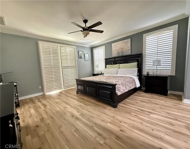 a bedroom with a bed and a ceiling fan