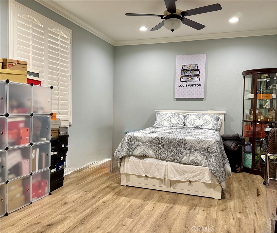 33467 Pitman Lane Menifee, CA 92584 - Photo 25 of 40 a bedroom with a bed and wooden floor