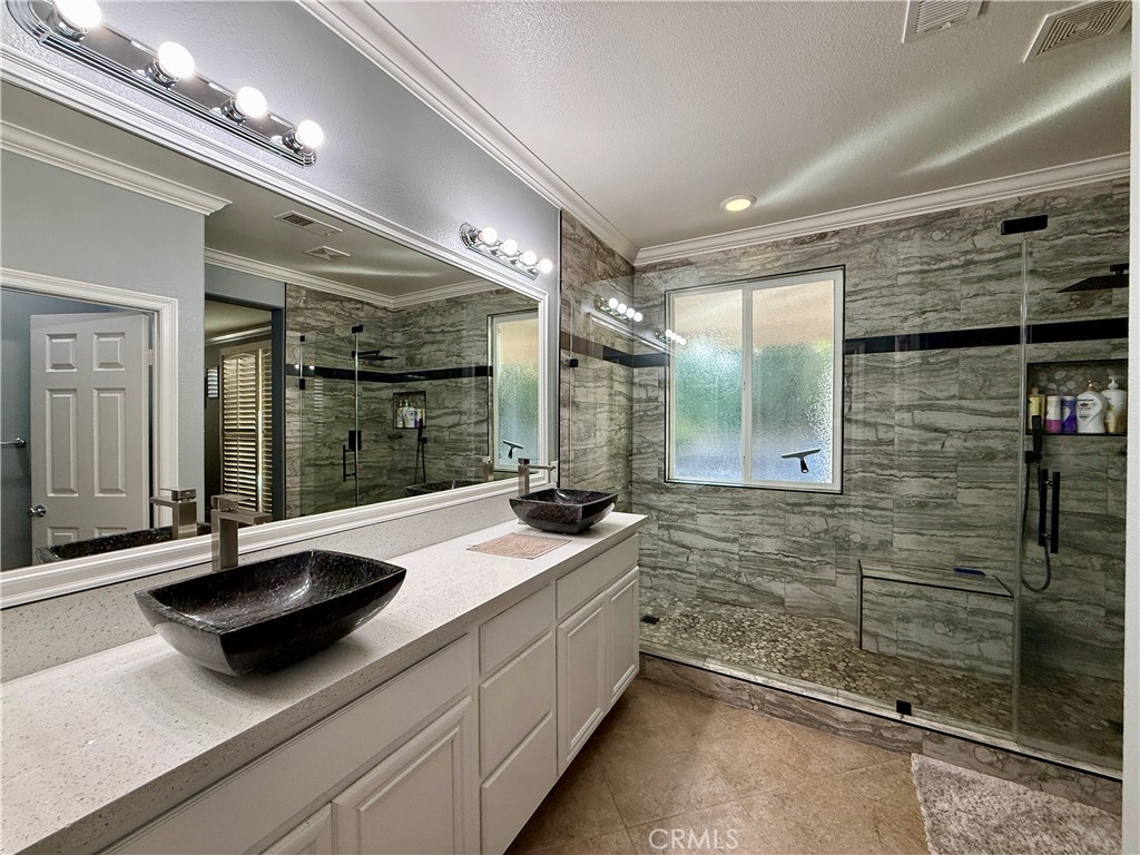 33467 Pitman Lane Menifee, CA 92584 - Photo 27 of 40 a bathroom with a sink and a shower