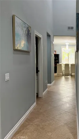 a view of a hallway with wooden floor and a living room