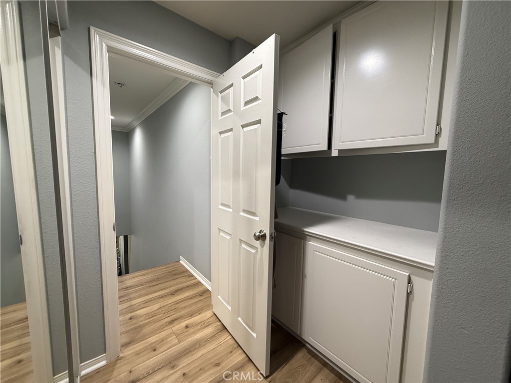 33467 Pitman Lane Menifee, CA 92584 - Photo 31 of 40 a view of a hallway with wooden floor and staircase