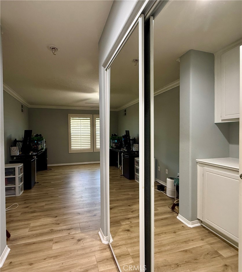 33467 Pitman Lane Menifee, CA 92584 - Photo 32 of 40 a view of a hallway with wooden floor and a living room